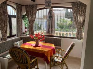 a dining room table with a vase of flowers on it at Casa Leon Cabo de Palos Costa Calida La Manga Mar Menor Mittelmeer Alicante Cartagena in Cabo de Palos +32 photos