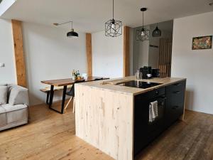 a kitchen with a wooden island in a room at spacious modern LOFT, 2 bedrooms, 95m2, free parking in Bratislava