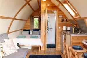 a small room with a bed in a tiny house at Badcall Bay Retreat in Badcall