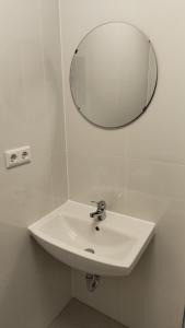 a white sink in a bathroom with a mirror at Apartment for 2 guests in Geesthacht