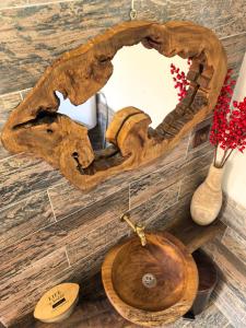 a bathroom with a wooden sink and a mirror at Къща Томови in Devin +108 photos