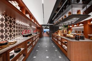 a restaurant with a long counter with food at Intercity Jinghong Xishuangbanna in Jinghong