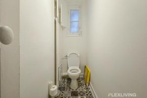 Un pequeño baño con inodoro y ventana. en Flexliving - Room - Henri Sellier - Suresnes 92, en Suresnes
