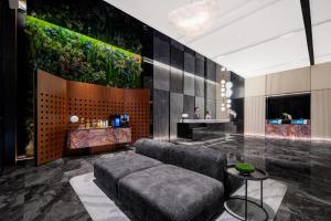 a living room with a couch and a table at Intercity Jinghong Xishuangbanna in Jinghong