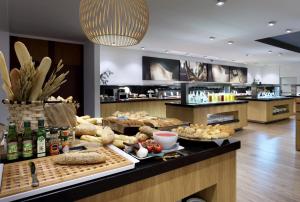 a display of food on a counter in a store at Barceló Bilbao Nervión in Bilbao