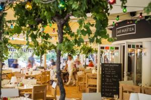 a restaurant with tables and people walking in the background at Ha(a)ïtza in Pyla-sur-Mer