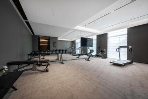 a gym with several exercise equipment in a room at Intercity Jinghong Xishuangbanna in Jinghong