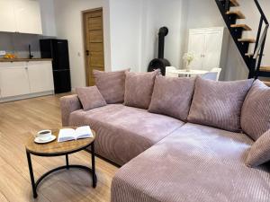 a living room with a couch and a table at Cozy Cottage in Oświęcim