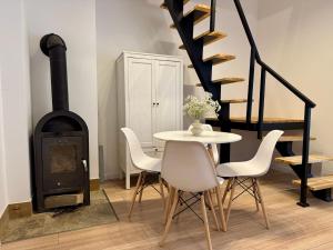 a dining room with a table and a wood stove at Cozy Cottage in Oświęcim