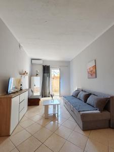 una sala de estar con un sofá y una mesa en Altura Rooms & Apartments, en Neum