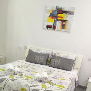 a bedroom with a bed with towels on it at One bedroom TEA apartment Il-Gzira in Il-Gżira