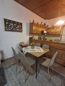 a kitchen with a dining room table and chairs at Aggelos Guest House in Orchomenós