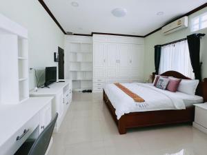 a bedroom with a bed and a television in it at Vanida Hotel in Vientiane
