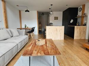a living room with a couch and a table at spacious modern LOFT, 2 bedrooms, 95m2, free parking in Bratislava