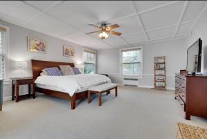a bedroom with a bed and a ceiling fan at Stunning, Large, Waterfront Retreat in Highlands
