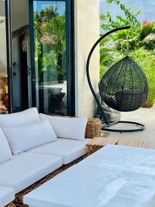 a living room with a white couch and a basket at Villa Aora Bingin Large 4 Bedroom Villa in Uluwatu