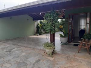 a house with a patio with a table and a plant at Hotel Vila Solar in Limeira