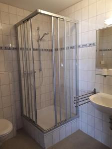 a shower with a glass door in a bathroom at Pension Elisabeth in Cochem +52 photos
