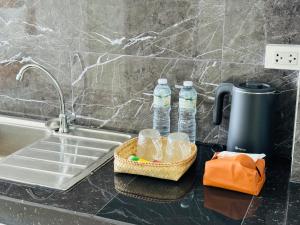a kitchen counter with two bottles of water next to a sink at Vanida Hotel in Vientiane +79 photos