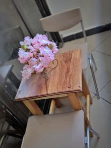 a table with a bouquet of flowers on top of it at Sielle Apartment-Sunsweet Resort shanzu beach0116&570&504with pool in Mombasa