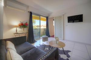 a living room with a couch and a table at Isa - Clim - WiFi - Balcon - VCA in Le Cannet