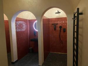 a bathroom with red walls and a shower and a sink at UrbanSpa - Prague 1 in Prague