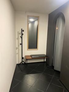 a room with a mirror and a bench in it at UrbanSpa - Prague 1 in Prague