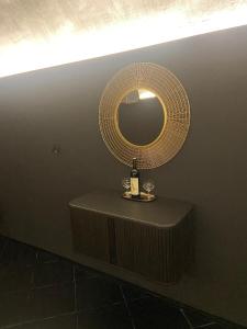 a table with a bottle of wine and a mirror at UrbanSpa - Prague 1 in Prague