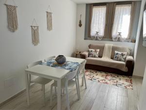 a living room with a table and a couch at Casa Manila Isola d'Elba in Portoferraio