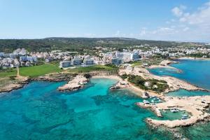 an aerial view of a resort and the ocean at SeaTurtle Beach House in Paralimni