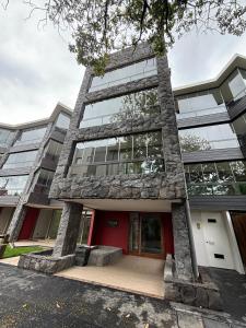 a large building with a red door at Agradable loft en Pucón in Pucón