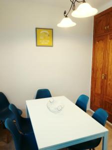 a meeting room with a white table and blue chairs at Casa Luna in Santiago de la Ribera +49 photos