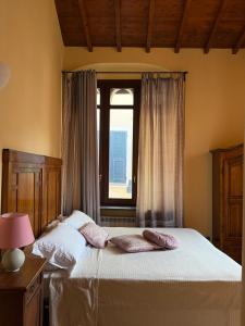 a bedroom with a large bed with a window at Levanto Charme apartment up to 6ppl 20 steps to the water in the center in Levanto