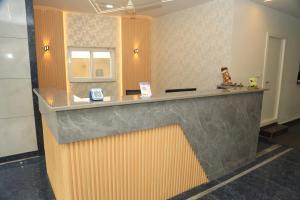 a lobby with a reception desk with a counter at Hotel VARRAHI EXOTICA in Hyderabad