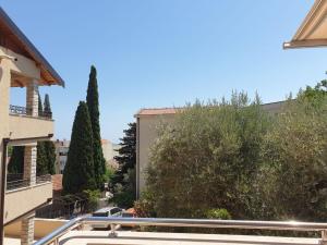a view from a balcony of a building with trees at Victor Apartments in Petrovac na Moru +4 photos