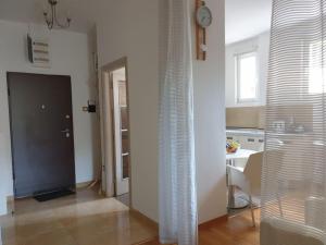 a room with a door and a kitchen with a table at Victor Apartments in Petrovac na Moru