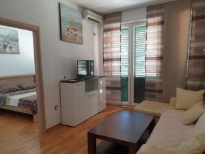 a living room with a couch and a coffee table at Victor Apartments in Petrovac na Moru