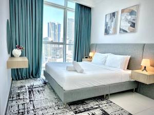 a bedroom with a large bed and a large window at Majestic Tower in Dubai +131 photos