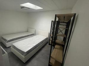 two bunk beds in a room with a ladder at Les embruns IV in Saint-Jean-de-Monts