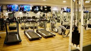a gym with several treadmills and cardio machines at SeaView 202 in Caesarea