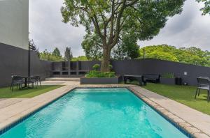 a swimming pool in the backyard of a house at The Bolton serviced apartments Rosebank in Johannesburg