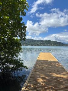 a wooden dock in the middle of a body of water at Villa Libel'ulle in Le Robert