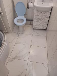 a white bathroom with a toilet and a sink at Villa Sun & Sea in Constanţa +21 photos