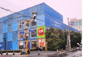 a blue building on a city street with a traffic light at Yoolim stay # 건대입구# 성수# 잠실롯데타워 in Seoul