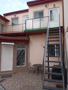 a ladder leading up to a house with a patio at Villa Sun & Sea in Constanţa