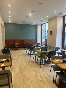 an empty dining room with tables and chairs at JR Hotels Bocconi Milano in Milan