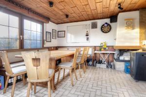 a dining room with a wooden table and chairs at Mill Nordkirchen in Nordkirchen