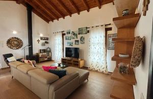 a living room with a couch and a television at Villa Volcan2 Rural Private Pool la Oliva by Holidays Home in La Oliva