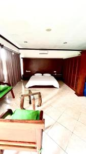 a bedroom with a bed and a table in a room at Green Kuta Apartement in Seminyak