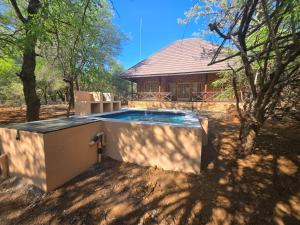 a hot tub in front of a house at Dumela Afrika in Marloth Park